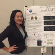 Alexis Delgado standing in front of research poster