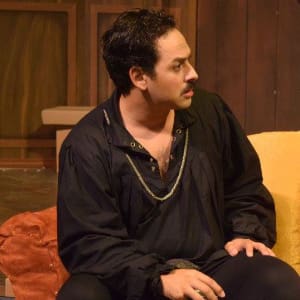 Young man performing theatre on stage