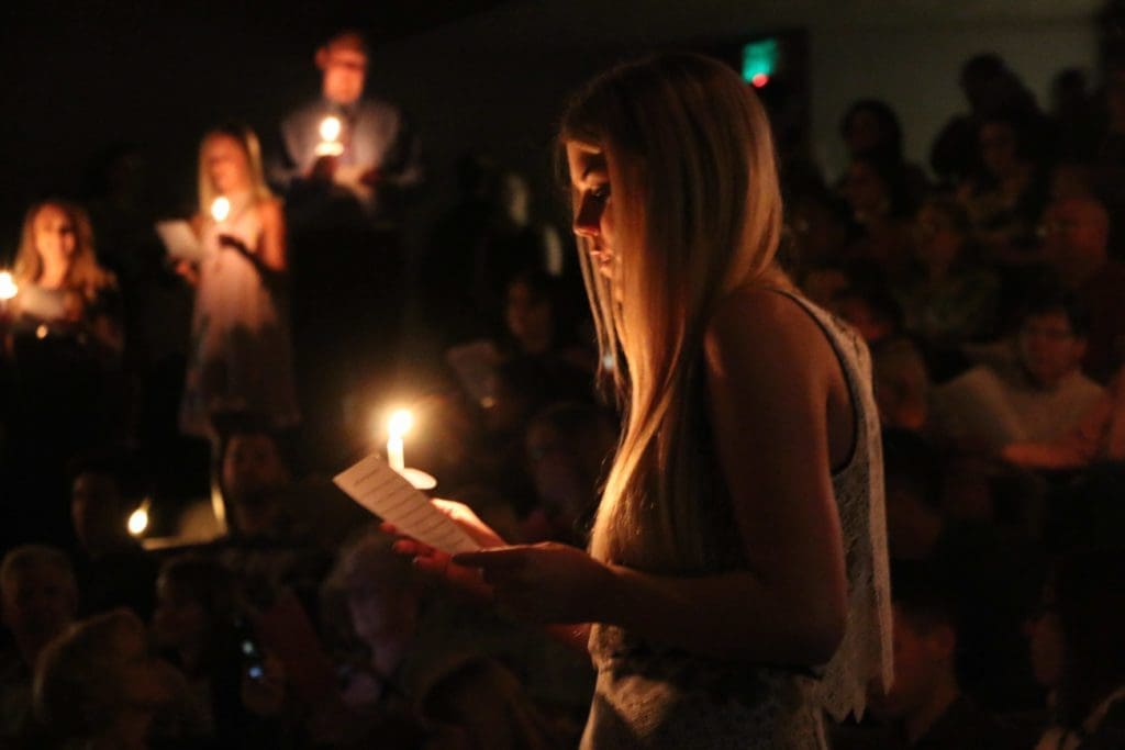 Nursing students read in unison during the candlelight portion of their pinning ceremony
