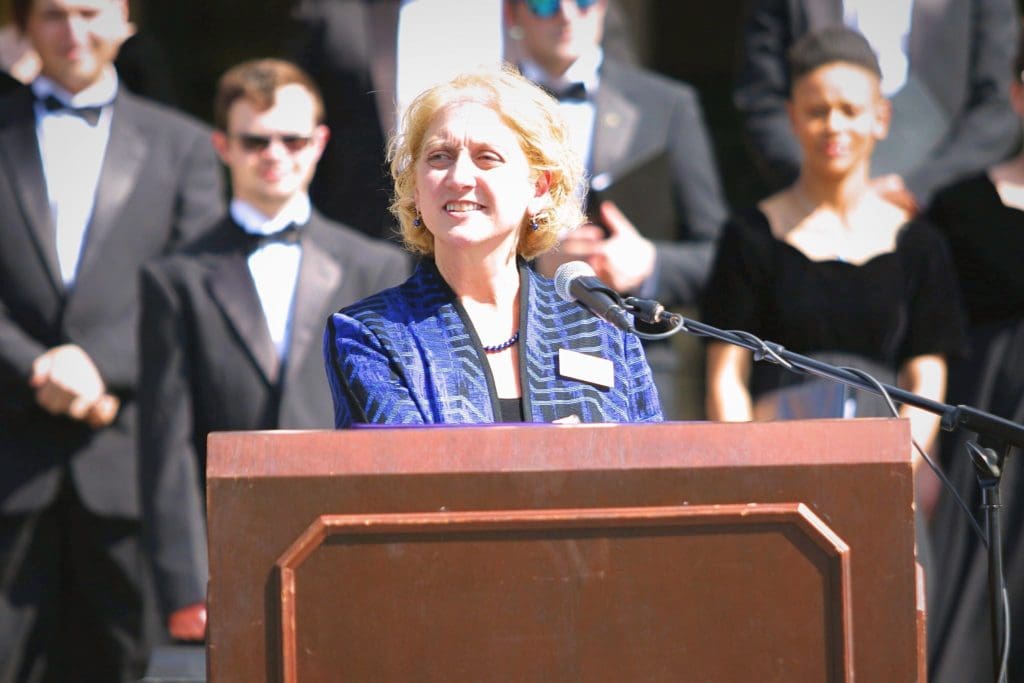 Professor Charlene Gould at the podium at the Goppert Performing Arts Center